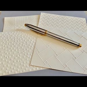 Twelve embossed notecards on cream card stock.